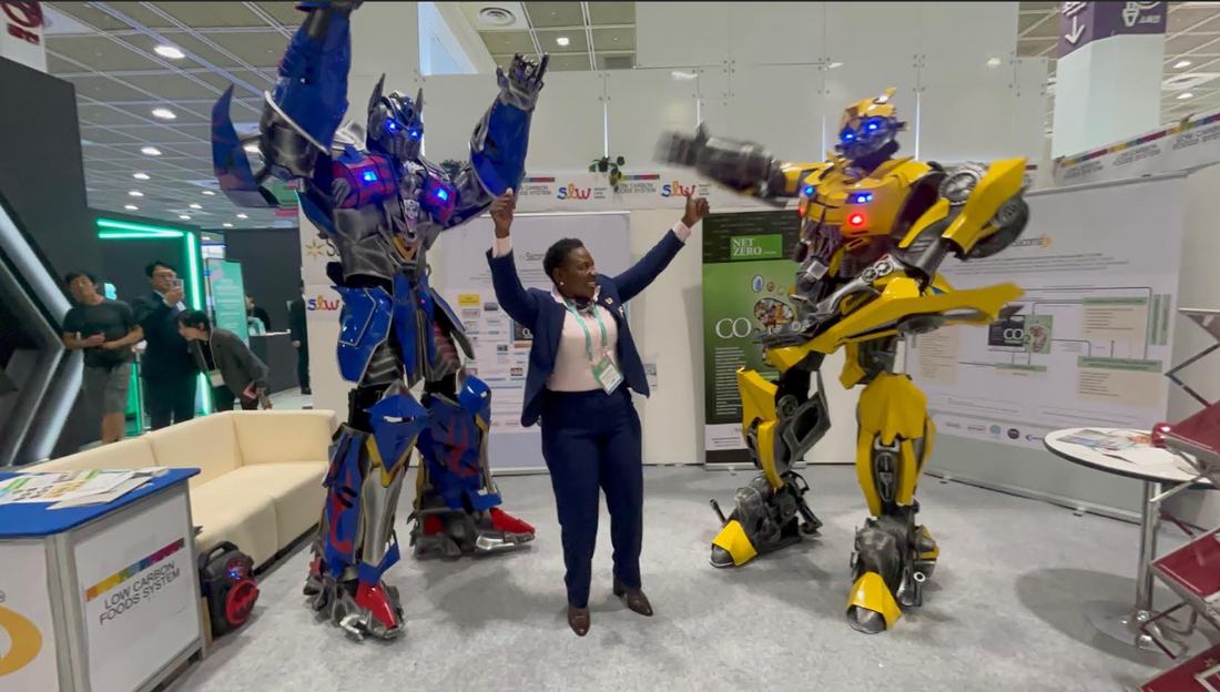 Perez Ochieng with AI robot characters at Smart Life Week