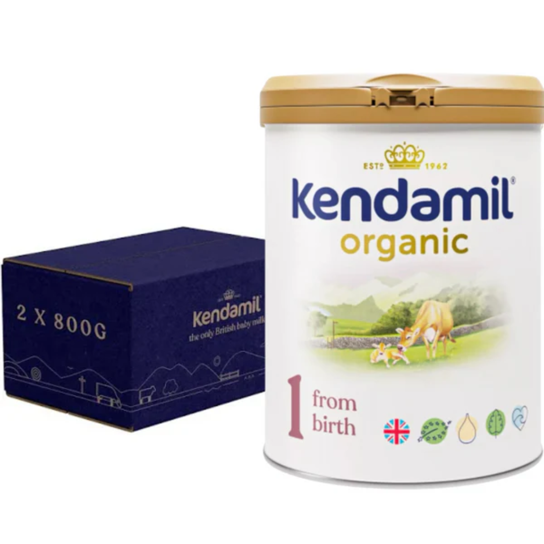 A canister of Kendamil Organic First Infant Milk, with a label showing a green field and cow, indicating it is organic.