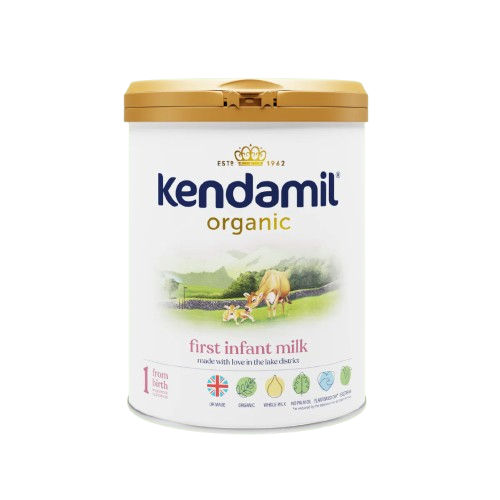 A canister of Kendamil Organic First Infant Milk, with a label showing a green field and cow , indicating it is organic.