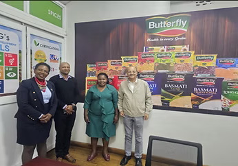Sacoma team and partners in front of a branded retail shelf display