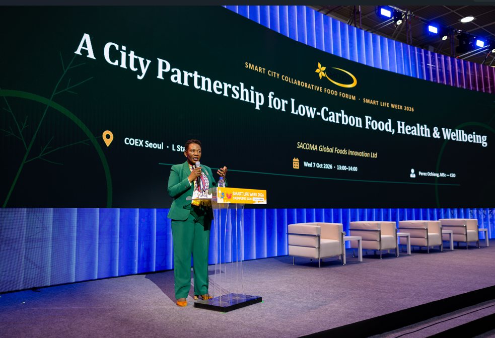 Perez Ochieng speaking at COEX Seoul beneath a screen reading A City Partnership for Low-Carbon Food, Health and Wellbeing