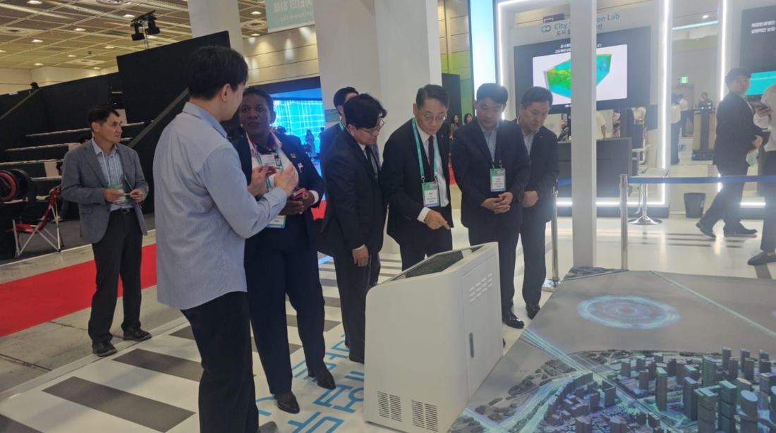 Perez Ochieng touring a smart-city exhibit with delegates in Seoul